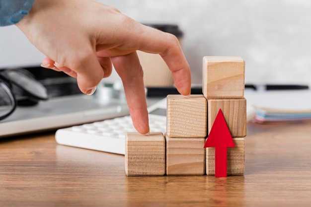 hand-climbing-wooden-blocks-represent-growth_23-2148780589